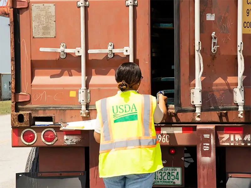  USDA personnel inspecting a cargo container