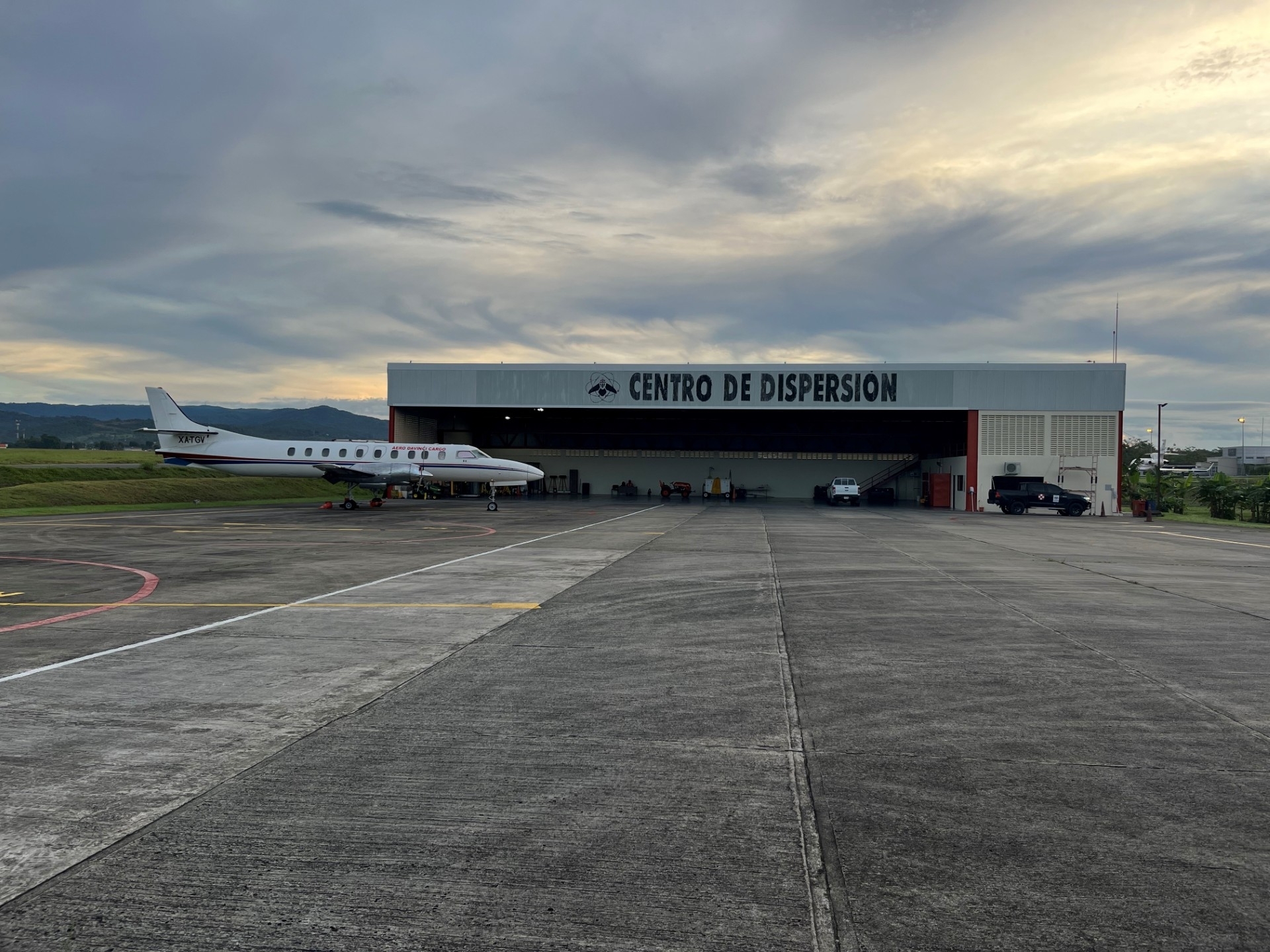 large building/facility with an airplane parked in front