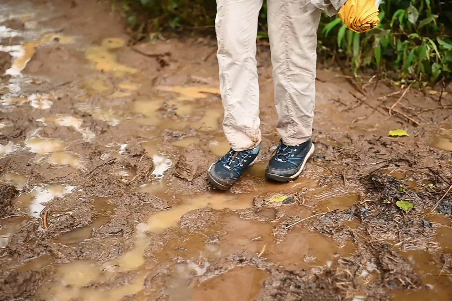 Muddy hiking boots on a forest trail